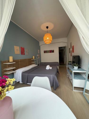 a bedroom with a bed and a table and a television at RighePois in Reggio di Calabria