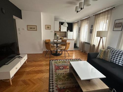 a living room with a couch and a table at Layla's Home Free Parking in Sarajevo