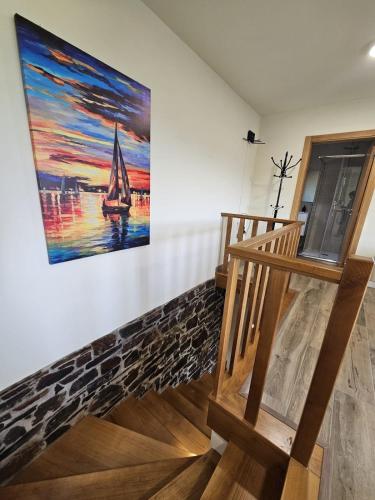 a painting of a sailboat on a wall next to a staircase at Casa dos Pobres in Castro Daire