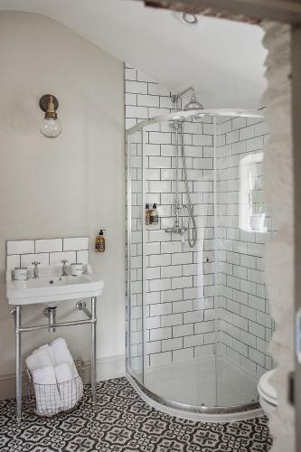 a bathroom with a shower and a sink at Ty Bach in Llanwrtyd Wells