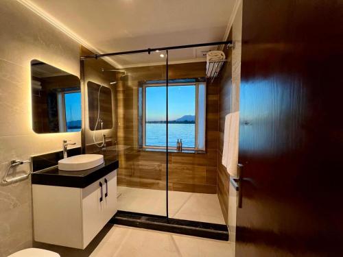 a bathroom with a sink and a shower with a window at SWAN DAHABIYA Luxury Boutique Nile Cruise - Every Friday from Aswan for 3 nights & Every Monday from Luxor for 4 nights in Luxor