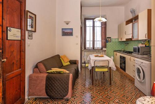 a living room with a couch and a table in a kitchen at Eco B&B I Due Oleandri in Marina di Carrara