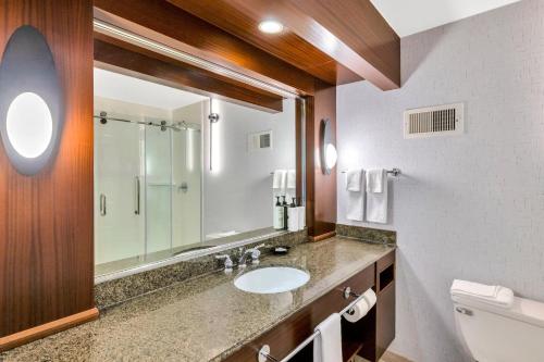 a bathroom with a sink and a mirror at Crowne Plaza Hotel Foster City-San Mateo by IHG in Foster City