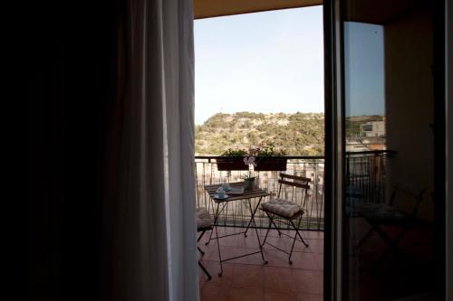 a view of a balcony with a table and chairs at La Casa di Nonna Concettina in Modica