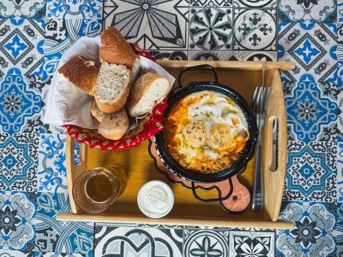 a tray with a bowl of food with bread and a bowl of soup at Freebird Surfcamp Morocco in Agadir