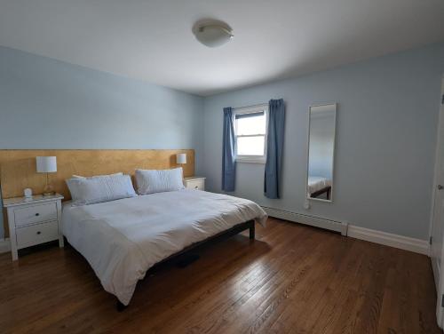 a bedroom with a large bed and a window at Atlantic Oasis in Halifax