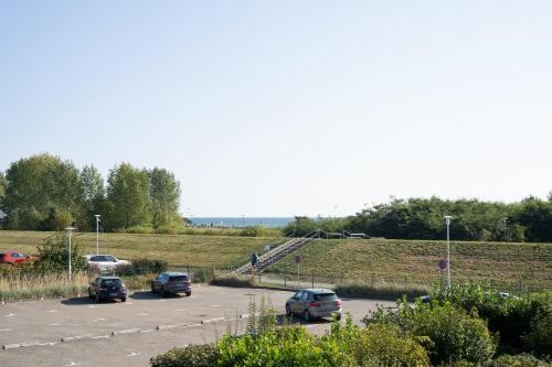 a parking lot with several cars parked in it at Baltic Wohnung 134 in Grömnitzerhagen