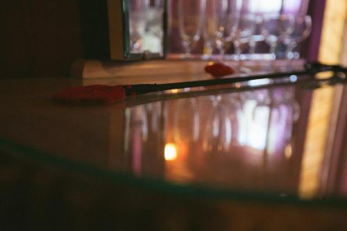 a close up of a table with wine glasses at Viesu nams Melnsils in Melnsils