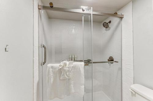 a bathroom with a shower with white towels at Seaview Sunsets in Marco Island