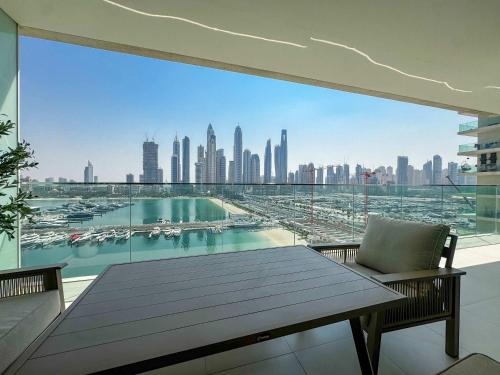 a balcony with a table and a view of a harbor at Glamorous 3BR with Marina view in Dubai