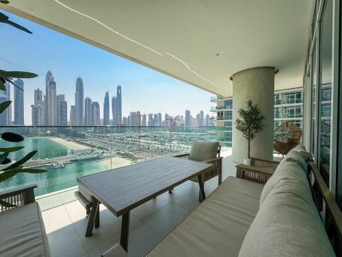 a balcony with a table and a view of a city at Glamorous 3BR with Marina view in Dubai