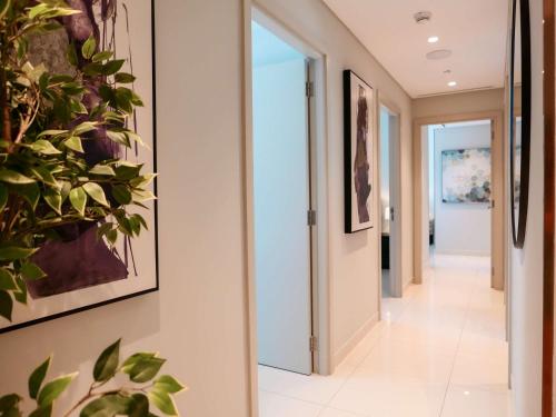 a hallway in a house with paintings on the walls at Glamorous 3BR with Marina view in Dubai