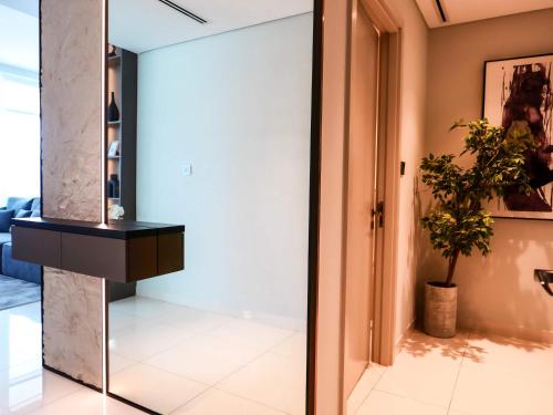 a room with a mirror and a potted plant at Glamorous 3BR with Marina view in Dubai