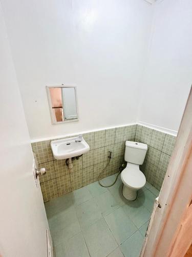a bathroom with a toilet and a sink at Paradiso Hostel El nido in El Nido