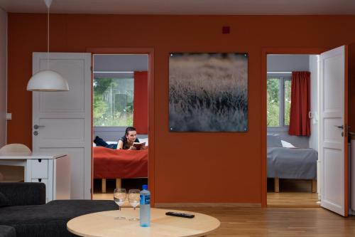 a person laying on a bed in a room at Dolmsundet Hotell Hitra in Melandsjøen