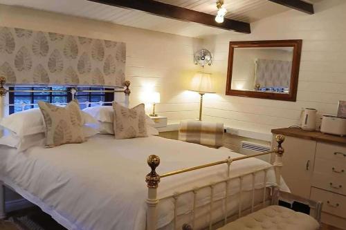 a bedroom with a large white bed and a mirror at 1 Bed Lodge - Southampton - Sleeps 2 - Parking in Southampton
