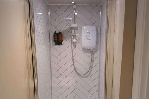 a shower in a bathroom with a white tiled wall at 1 Bed Lodge - Southampton - Sleeps 2 - Parking in Southampton