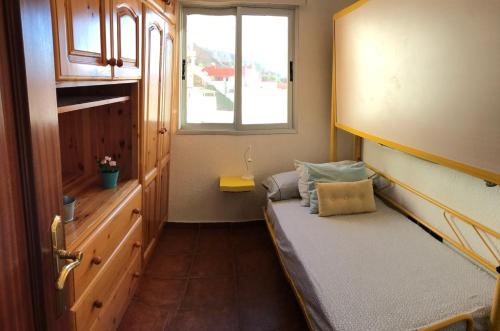 a small room with a bed and a window at WONDERFUL Sea Views El Pris in El Pris