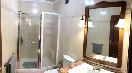 a bathroom with a shower and a sink and a mirror at WONDERFUL Sea Views El Pris in El Pris