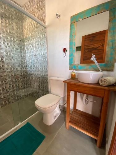 a bathroom with a toilet and a sink and a shower at Pousada Recanto Namastê - Mandalah in Cunha
