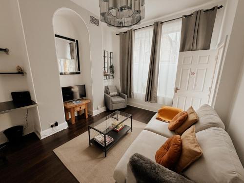 a living room with a couch and a chair at Rialto luxury apartments Bath ! in Bath