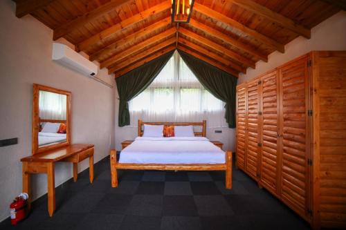 a bedroom with a bed and a large window at Asil Villas in Sapanca