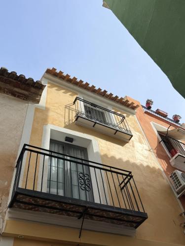 a building with two balconies and a balcony at Pou by Seaward Suites in Villajoyosa