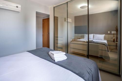 a hotel room with a bed with towels on it at Point Convenience by Marzani Host in Goiânia