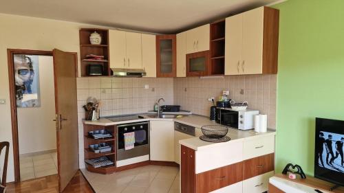 a kitchen with a sink and a stove top oven at Mathilda's Apartment in Španjola