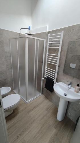 a bathroom with a shower and a toilet and a sink at Casa del centro in Leinì