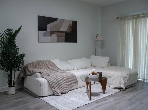 a white living room with a bed and a table at Townhome in North Austin in Austin