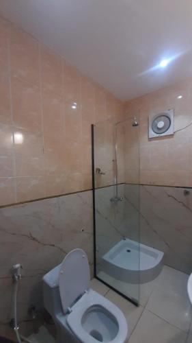 a bathroom with a toilet and a glass shower at دريم لاند صامطة - Dream Land Samtah in Şāmitah