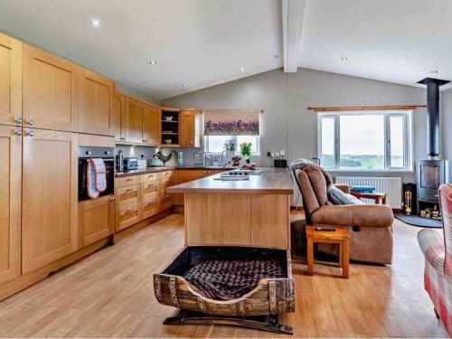 a kitchen with a island in the middle of a room at Drovers Lodge, farm retreat in rural Lanarkshire, family and pet friendly, onsite craft distillery, perfect location for exploring central Scotland in Forth