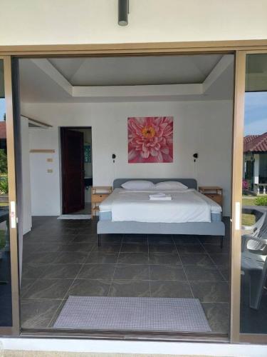 a bedroom with a bed and a large glass window at The1 Mangosteen Harmony Retreat - Khaolak - Eco Luxury Villa - Room Only -No Breakfast in Khao Lak