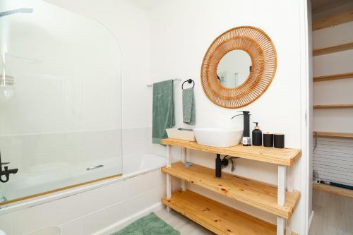 a bathroom with a sink and a mirror at Dune Sanctury in Keurboomstrand