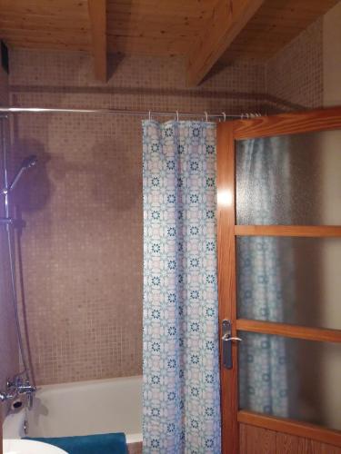 a bathroom with a shower curtain and a tub at Can Mayol in Alaró