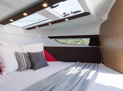 a bed in the middle of a van with a window at Le Rafifou Porquerolles in Hyères