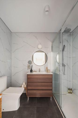 a bathroom with a sink toilet and a shower at Casa da Ponte in Amarante