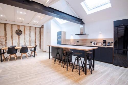 an open kitchen with a large island and bar stools at La Maison Renaissance Amboise 4 bedroom house in Amboise