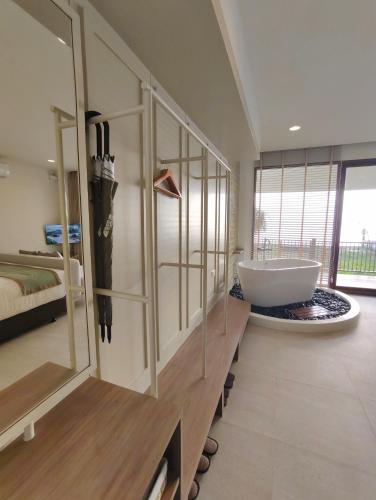 a bathroom with a bath tub in a room at Baan Imm Sook Resort in Chao Lao Beach