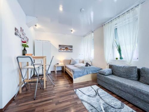 a living room with a couch and a table at AugsburgLiving - Business- und Ferienapartments in Augsburg