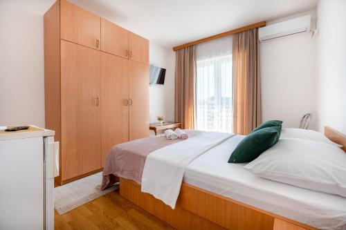 ネウムにあるApartments&Rooms La Putalinaの大きなベッドと大きな窓のある寝室