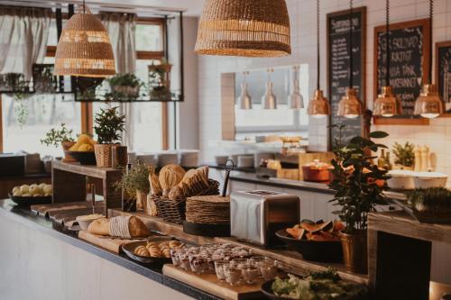a bakery with bread and other food on a counter at Home Hotel Slottsparken in Linköping