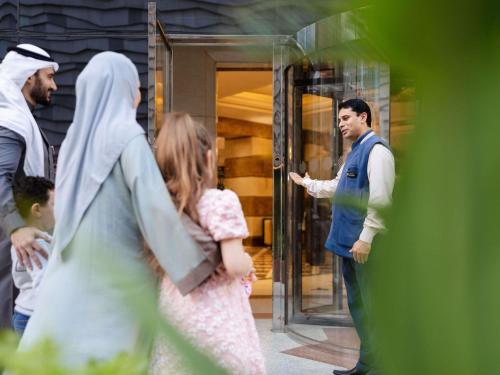 a group of people standing outside of a door with a doctor at Zamzam Pullman Madina in Al Madinah