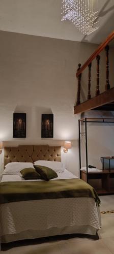 a bedroom with a large bed and a staircase at Arvore da Vida Pousada in Itaguaí
