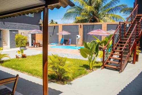 a house with a staircase leading to a pool at Pousada do Enildo in São Miguel dos Milagres