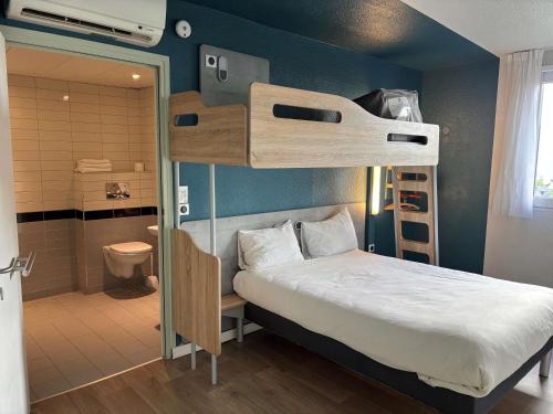 a bedroom with a bunk bed and a bathroom at ibis Budget Le Treport Mers Les Bains in Mers-les-Bains