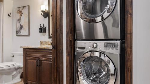 a washer and dryer in a bathroom next to a toilet at Holiday Inn Club Vacations Scottsdale Resort in Scottsdale