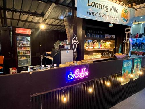 a bar in a restaurant with a neon sign at Lanting Villas in Koh Rong Island