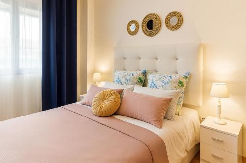a bedroom with a large bed with two mirrors on the wall at Apartment las sirenas -WiFi 100 Mb-, Sea view in Roquetas de Mar